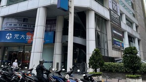 A modern building with multiple floors, large windows, and a prominent blue banner with white text. - Formosa101 Taipei Main Branch (Taipei)