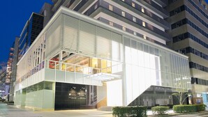 A modern building with a glass facade and a prominent entrance. - KOKO HOTEL Kobe Sannomiya (Kobe)