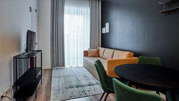 Signature Apartment | Living area | 32-inch flat-screen TV with digital channels, TV