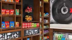 A snack aisle with various packaged snacks and a large sign indicating the section. - Hampton Inn Tappahannock (Tappahannock)