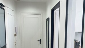 A hallway with white doors, black-framed mirrors, and a radiator on the wall. - T2 41 m2 CANNES bas SUQUET with parking, near beach and town center (Cannes)