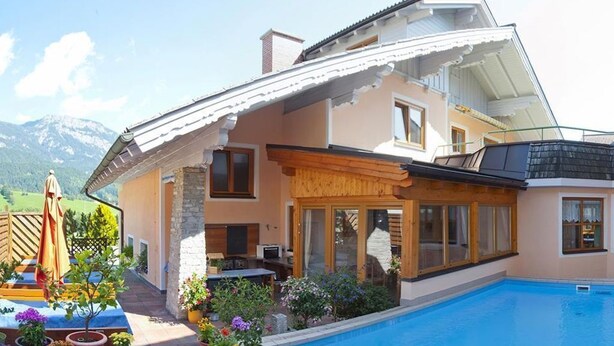 A house with a swimming pool, wooden deck, and potted plants. - Four-bed room with bath, WC - B&B - Golf- und Skipension Krug (Haus)