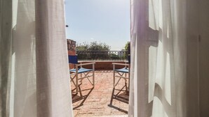An outdoor patio area with two blue chairs and a stone wall in the background. - Il Borgo Apartments A1 - Sv-d600-bove3ata (Finale Ligure)