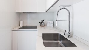 A modern kitchen with two stainless steel sinks, a kettle, and a paper towel dispenser. - Il Borgo Apartments C3 - Sv-d600-navi44c1c (Finale Ligure)