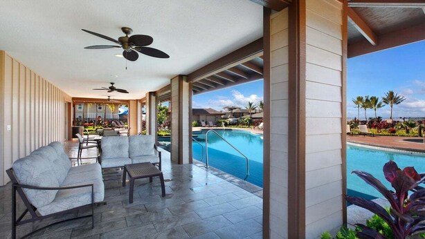 A covered outdoor area with seating, a pool, and a view of the resort. - Pili Mai 12L Central AC By Suite Paradise (Koloa)