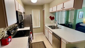 A compact kitchen with a microwave, toaster, and refrigerator.
