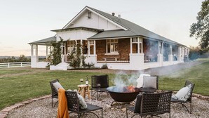 A house with a fire pit and outdoor seating. - 'Mayfield' - Luxury Farmhouse with Pool (Mayfield)
