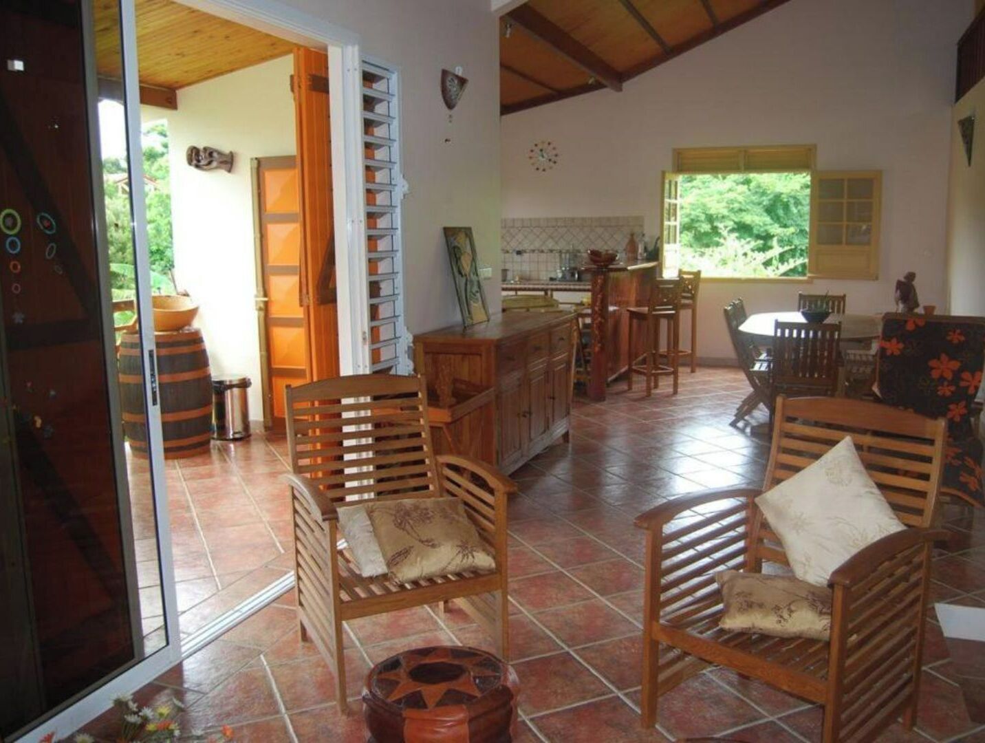 A spacious kitchen with wooden cabinets and a dining area with a table and chairs.
