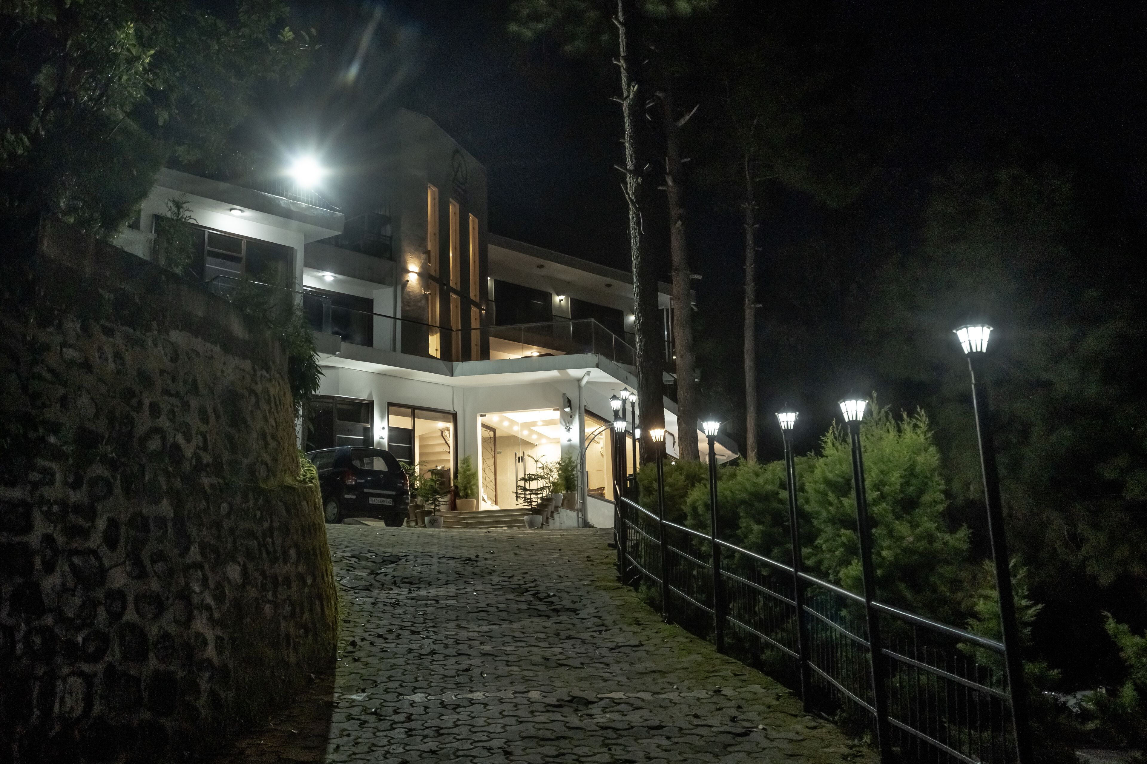A modern building with a stone pathway leading to the entrance.