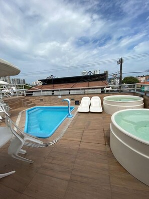 Outdoor pool, open 6:00 AM to 10:00 PM, pool loungers