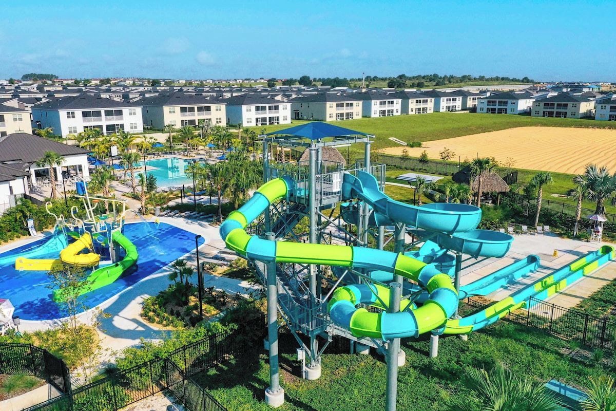 A water park with multiple slides and a pool area, surrounded by residential buildings.