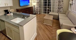 Relax in this inviting space with a comfortable sofa, double sink, and oven.