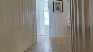 A wooden staircase leading to a room with white paneled walls and a framed picture on the wall. - House (ST MARTIAL DE NABIRAT)
