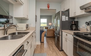 Enjoy cooking in this well-equipped kitchen with a central island, stainless steel appliances, and ample counter space.