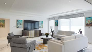 Regent Suite | Living area | 65-inch flat-screen TV with cable channels, TV, Netflix
