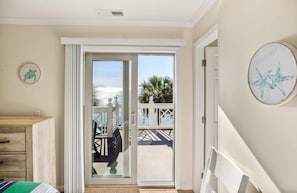 Relax in this serene hotel room with an outdoor area, featuring a comfortable bed and a stylish dresser.