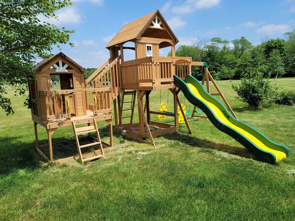 A wooden play structure with a slide and climbing areas. - Great home to unwind 15 minutes from Champaign Urbana and University of Illinois (Sidney)