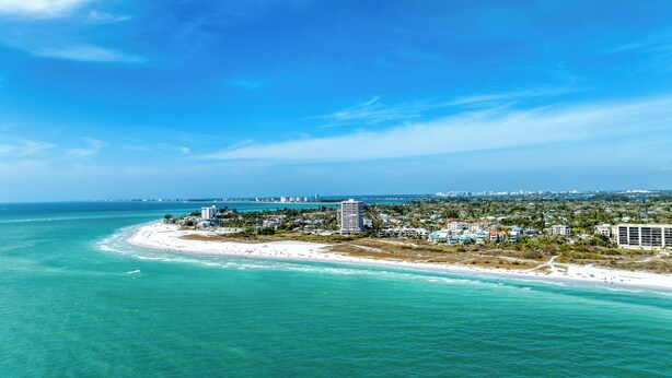 A coastal resort with beachfront properties, a marina, and a clear view of the ocean. - Perfect location Walk to the village and beach Private Balcony Heated Pool (Siesta Key)