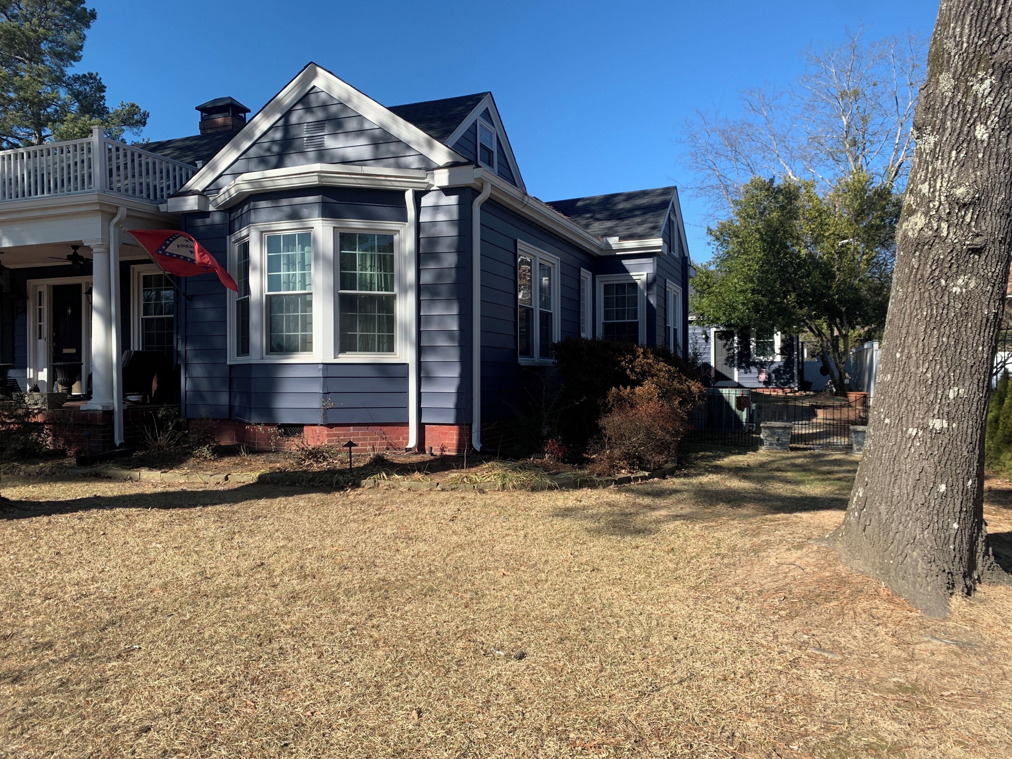 A two-story house with a gabled roof, a front porch, and a brick foundation.