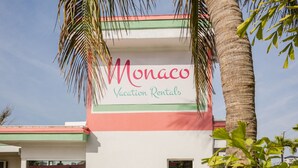 A building with a sign that reads 'Monaco Vacation Rentals.' - 108 · ☀Pool✔ Kitchen✔ Beach✔ Self Checkin✔ Free Parking✔ (Clearwater)