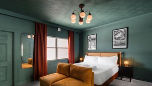 A bedroom with a bed, a wooden headboard, a nightstand, a lamp, a window with curtains, a mirror, and a framed picture on the wall. - 108 · ☀Pool✔ Kitchen✔ Beach✔ Self Checkin✔ Free Parking✔ (Clearwater)