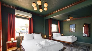 A hotel room with two beds, a large window, a ceiling fan, and a rug. - 114 · Pool Beach Self Checkin Free Parking (Clearwater)
