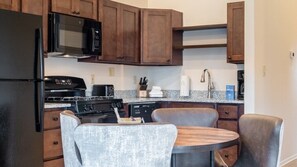 Fridge, microwave, coffee/tea maker, cookware/dishes/utensils