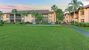 Stunning residential building with a central entrance and beautifully manicured lawn.