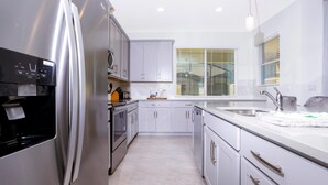 Condo, Multiple Beds (2182 FMP - 4BR Luxury Townhome Pool D) | Private kitchen | Dishwasher, high chair, cookware/dishes/utensils, paper towels - 2182 FMP - 4BR Luxury Townhome Pool Disney (Kissimmee)