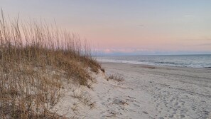 A beach with sand and sparse vegetation. - The Bee's Knees-Adorable Cottage w/Optional Golf Cart (Oak Island)