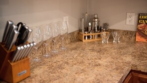 A kitchen counter with a knife block, wine glasses, and a coffee maker. - Peaceful 2-bedroom Townhome Just Steps Away from the Excitement of Pigeon Forge. (Pigeon Forge)