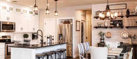 Fridge, coffee/tea maker, highchair, cookware/dishes/utensils