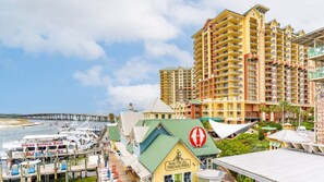 A coastal hotel with multiple high-rise buildings, a marina with boats, and a prominent nautical-themed building.