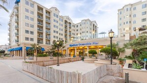 A hotel with multiple floors, outdoor seating, and a well-maintained garden area. - Club Wyndham Oceanside Pier Resort - 3 Bedroom (Oceanside)