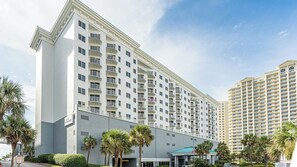 A multi-story hotel with balconies, a Club Wyndham sign, and palm trees.