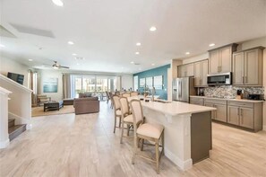 Enjoy cooking in this well-equipped kitchen with a central island, ample counter space, and integrated appliances.
