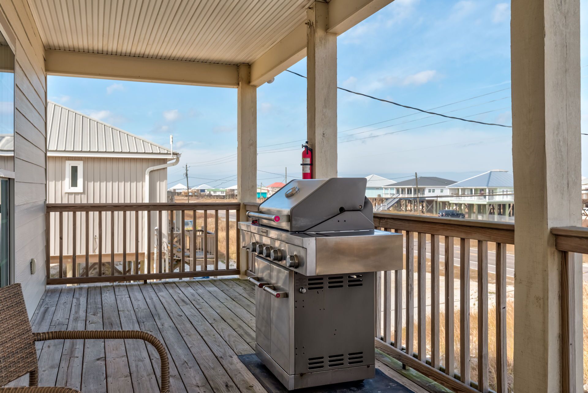 Your private covered deck features a premium gas grill where you'll savor outdoor cooking while enjoying peaceful neighborhood views.