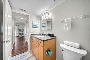 A bathroom with a wooden vanity, white sink, and a towel rack. - 3 bed 2 Bath, heated pool, walk to beach and village (Siesta Key)