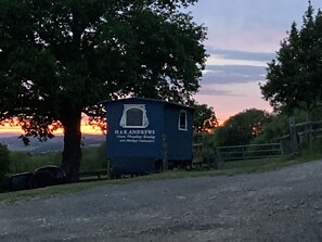 A small, single-story building with a sign reading "H&R ANDREWS Steam Puddling, Milling, and Lumber Carriers." - Pet Friendly - 2 Guests - Original Roadsmans Wagon (Longhope)