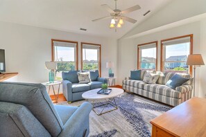 A spacious living room with two sofas, a coffee table, and a TV. - 5167 Wings As Eagles * 5 Min Walk to Beach (Kill Devil Hills)