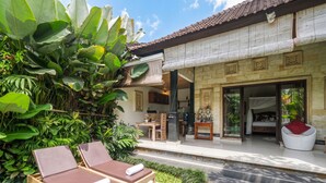 A tropical resort with a pool, lounge chairs, and lush greenery. - Villa Tirtha Amertha Ubud (Ubud)