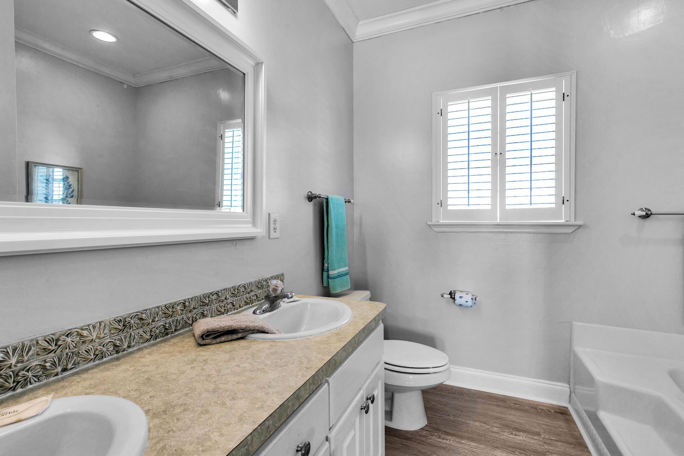 A bathroom with a sink, toilet, and bathtub.