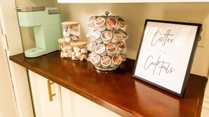 A coffee station with a sign that reads "Coffee 'till Cocktails".