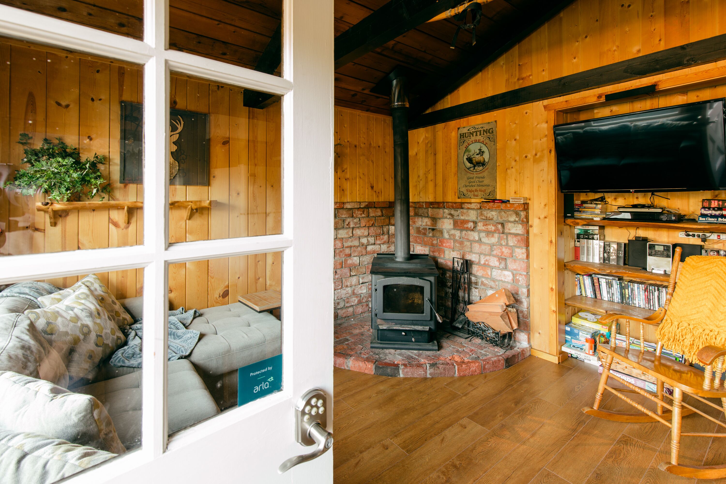 A cozy room with a fireplace, a television, and a bookshelf.