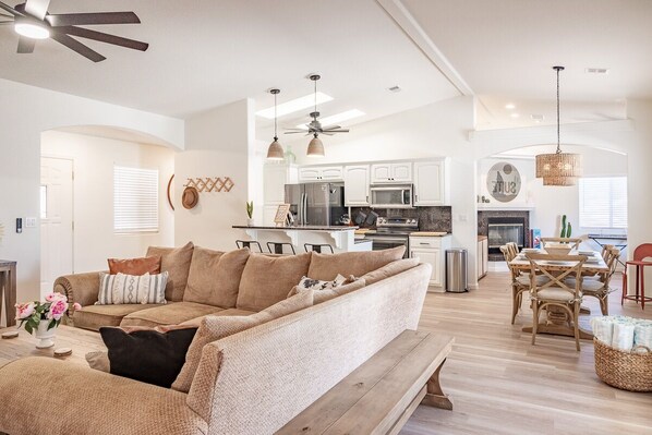 View from the hallway of the living room, dining, and kitchen. 