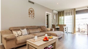 A modern living room with a sofa, coffee table, and a dreamcatcher decoration. - Jessmart by Interhome (Lloret de Mar)