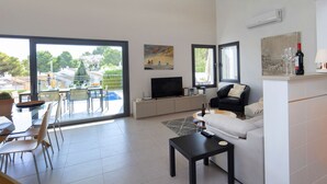 A modern living room with a TV, sofa, and dining area. - Bellveure by Interhome (Benissa)