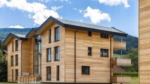 A modern wooden building with multiple floors, large windows, and a balcony. - Superior mit 3 Schlafzimmern & IR-Sauna by Interhome (Sankt Georgen am Kreischberg)