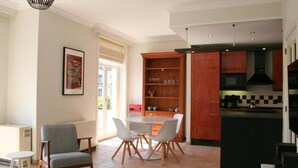 A modern kitchen with a built-in microwave, a black range hood, and a wooden cabinet.