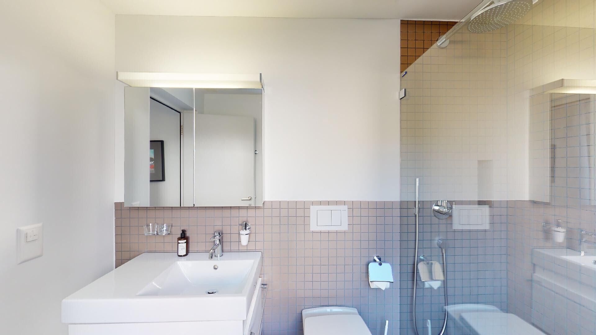 A modern bathroom with a double sink, a large mirror, a shower, and tiled walls.